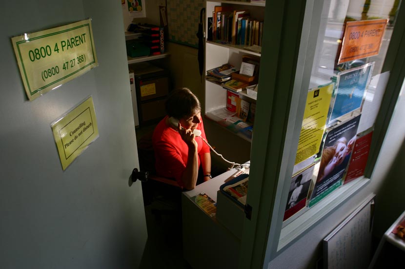 Woman in a room talking on the telephone.