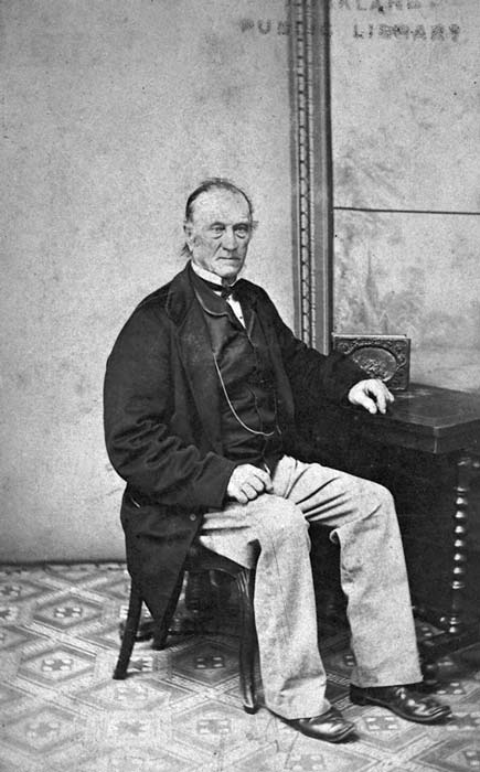 William White in later life seated beside a desk 