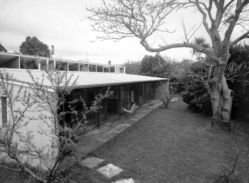 An exterior view of Mallitte House with lawn and trees