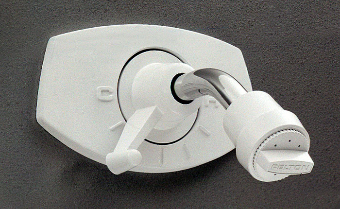 A photograph of a white plastic shower head and mixer.
