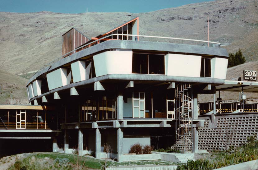 Large concrete and white modernist building in front of the Port Hills, Lyttelton. 