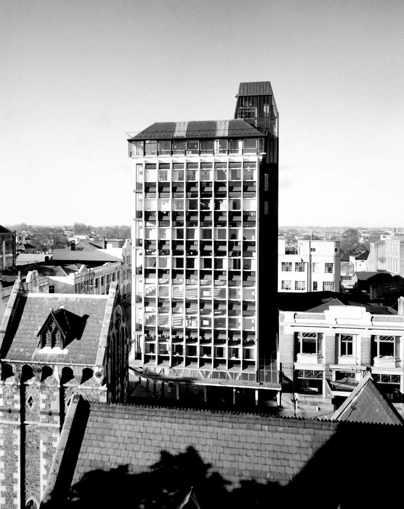 Tall multi-storey office building dwarfing the other buildings around it in central Christchurch. 
