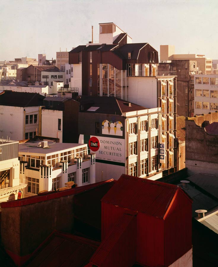 An Auckland streetscape showing a variety of buildings, including the Canterbury Arcade, projecting above the other buildings. 