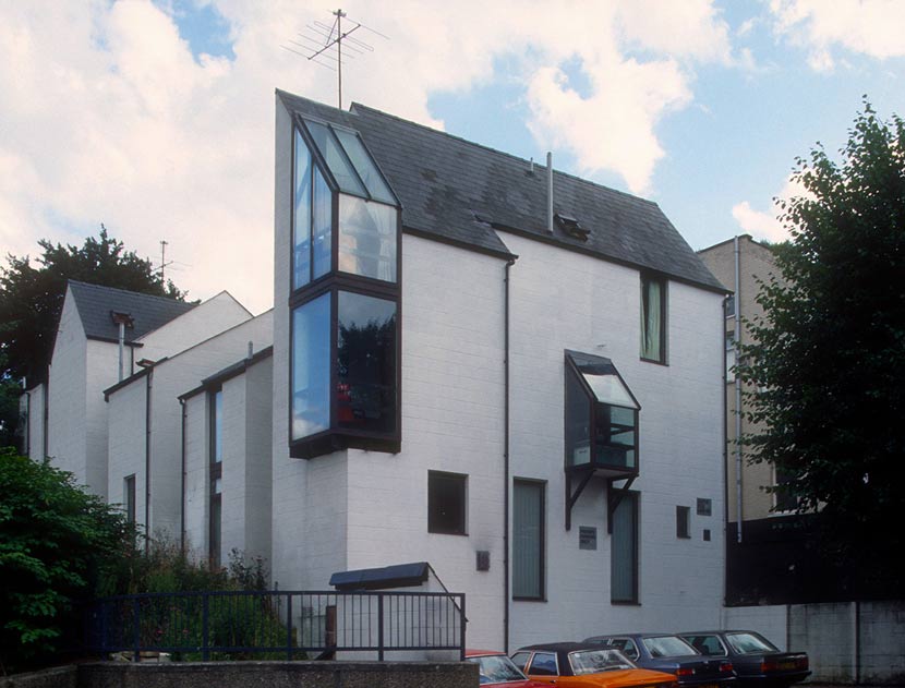 White townhouses of varied sizes and shapes. 