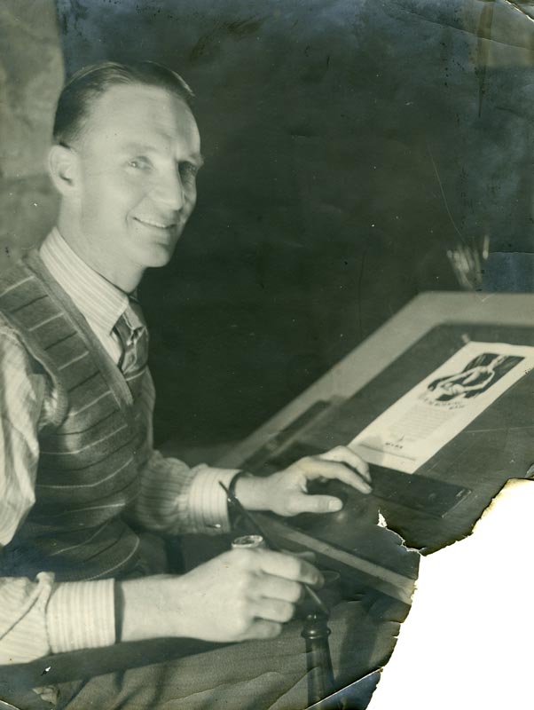 Bill Haythornthwaite as a young man, seated at an easel and holding a paintbrush.