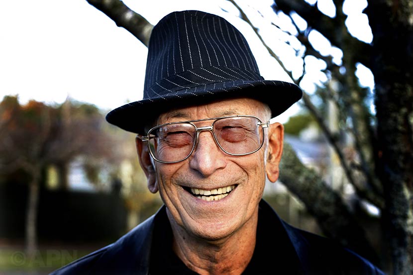 Ranginui Walker in later life, standing outdoors and smiling broadly.