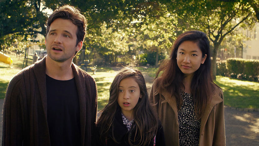A man, young girl, and a woman standing next to each other with surprised looks on their faces.