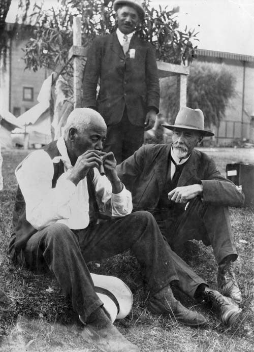 An unidentified Māori man is observed playing a nose flute