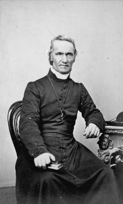A photograph of Antoine Garin seated and wearing clerical vestments