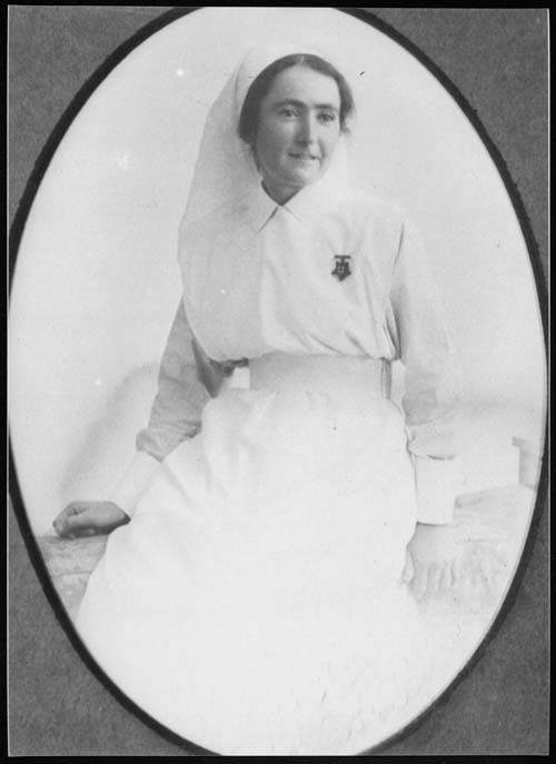 A three quarter length photograph of the young Kathleen Hall in a nurse's uniform