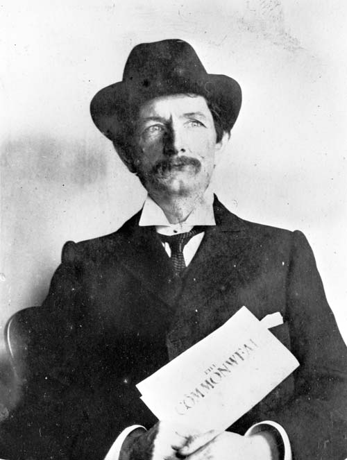 Robert Hogg holding a copy of the Commonweal, 1907