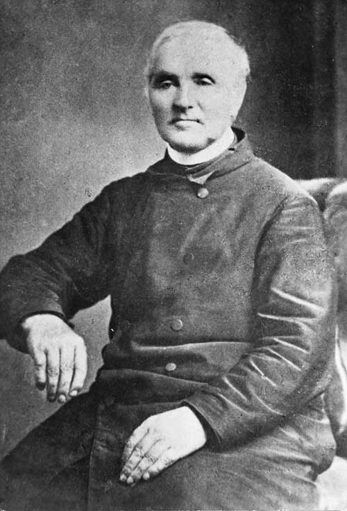 A photograph of Jean Lampila seated and wearing clerical clothing