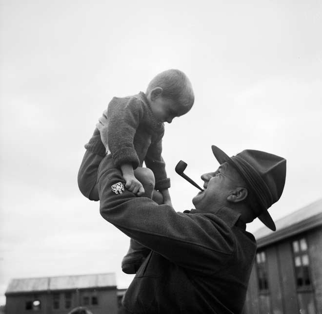 A soldier holds a Polish child, Pahīatua 