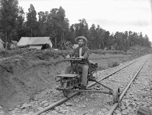 Man in a hat riding a railway jigger