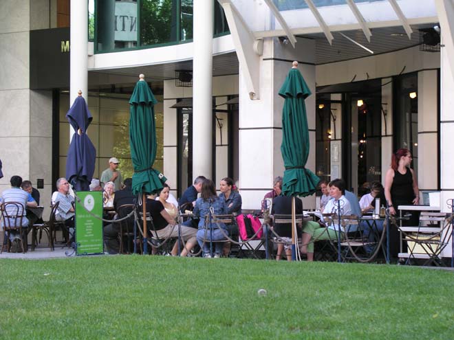 People eating at tables outside restaurant
