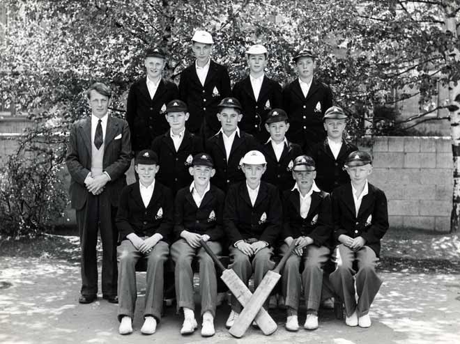 Cricket team in school uniform posing for group photo