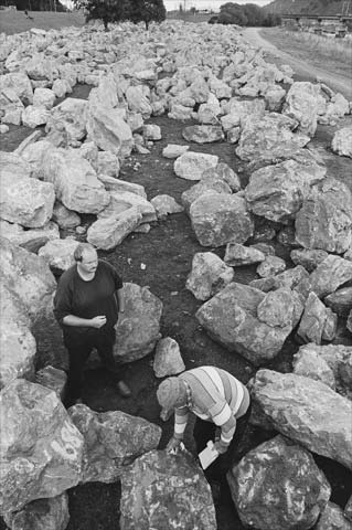 Two men surrounded by large boulders. 