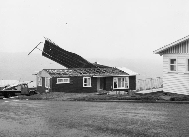 Roof of seaside house being blown off by he wind