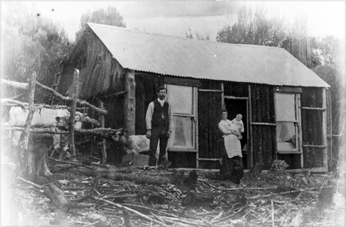 Family outside their hut