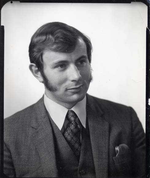 Man with sideburns in a suit