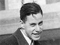A formally dressed young man standing outdoors
