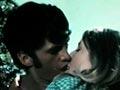 A Māori man and a white woman kissing