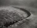 A trawl net being dragged across the sea floor, causing damage as it goes