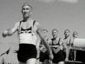 Men in surf lifesaving gear in a formal parade known as the 'march past'