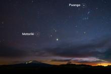 Night sky over mountain with Matariki and Puanga stars highlighted