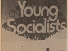 News Paper article showing people on stage with Young Socialists on banner behind