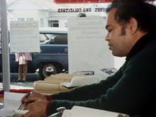 Man sitting down sorting papers