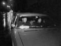 Two men in car driving at night