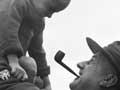 A soldier holds a Polish child, Pahīatua (2nd of 3)