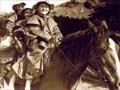 Three kids in oilskin coats on horseback
