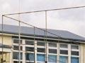 Two photos of same school  - one as single building the other as modern complex