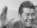 Smiling man waving hands