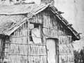 Family outside their whare