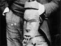 Thomas Morland Hocken with a Māori carving