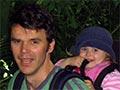 Man carrying young child in backpack