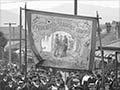 A Trade Union banner, one of many carried by a large demonstrating crowd