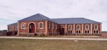 Large brick building in empty field