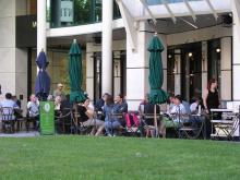 People eating at tables outside restaurant
