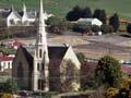 Small town on hill with prominent church in foreground