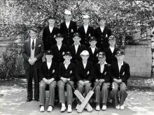 Cricket team in school uniform posing for group photo