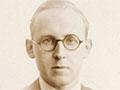 Sepia-coloured passport photograph of novelist James Courage
