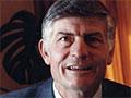 A colour head and shoulders photograph of Colin Murdoch wearing a suit and tie