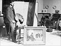 Sydney Lough Thompson at his easel surrounded by his works, probably after 1905