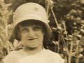 Young girl with hat standing on a path