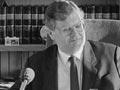 Lange gives a speech from his desk