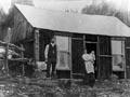Family outside their hut